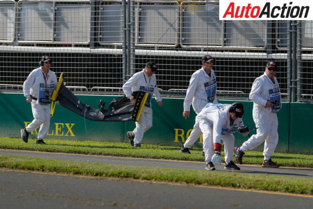 Officials recovering Daniel Ricciardo's front wing - Photo: LAT