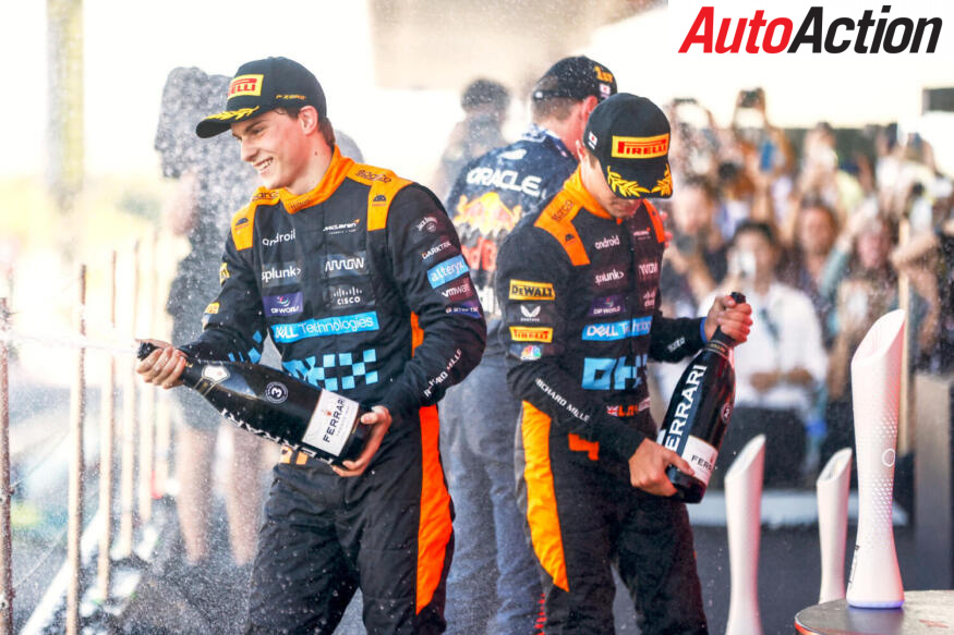 Oscar Piastri, 3rd position, and Lando Norris, McLaren, 2nd position, spray Champagne on the podium during the Japanese GP at Suzuka on Sunday September 24, 2023
