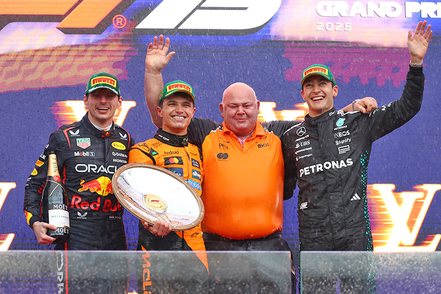 Max Verstappen, Lando Norris, Rob Marshall and George Russell on the podium of the 2025 Australian Grand Prix