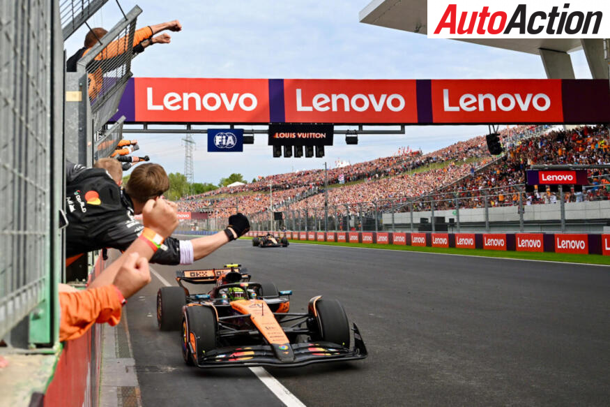 Lando Norris, McLaren, crosses the finish line in first place ahead of Oscar Piastri, McLaren, at the 2025 F1 Hungarian Grand Prix.