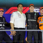 Race winner George Russell, Mercedes AMG Petronas F1 Team, second placed Max Verstappen, Oracle Red Bull Racing, third placed Lando Norris, McLaren, and Tengku Muhammad Taufik, CEO of Petronas celebrate on the podium after the 2025 F1 Singapore Grand Prix.