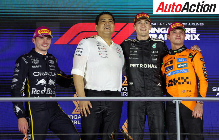 Race winner George Russell, Mercedes AMG Petronas F1 Team, second placed Max Verstappen, Oracle Red Bull Racing, third placed Lando Norris, McLaren, and Tengku Muhammad Taufik, CEO of Petronas celebrate on the podium after the 2025 F1 Singapore Grand Prix.